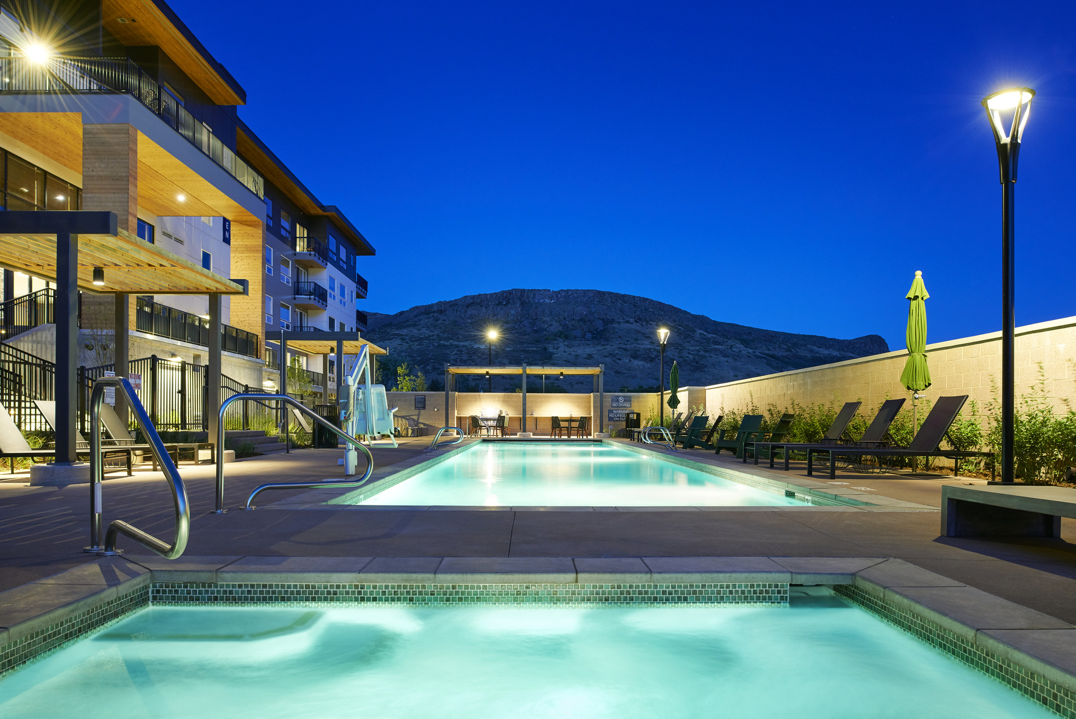 Image of Epoque Golden Apartment Community pool at dusk