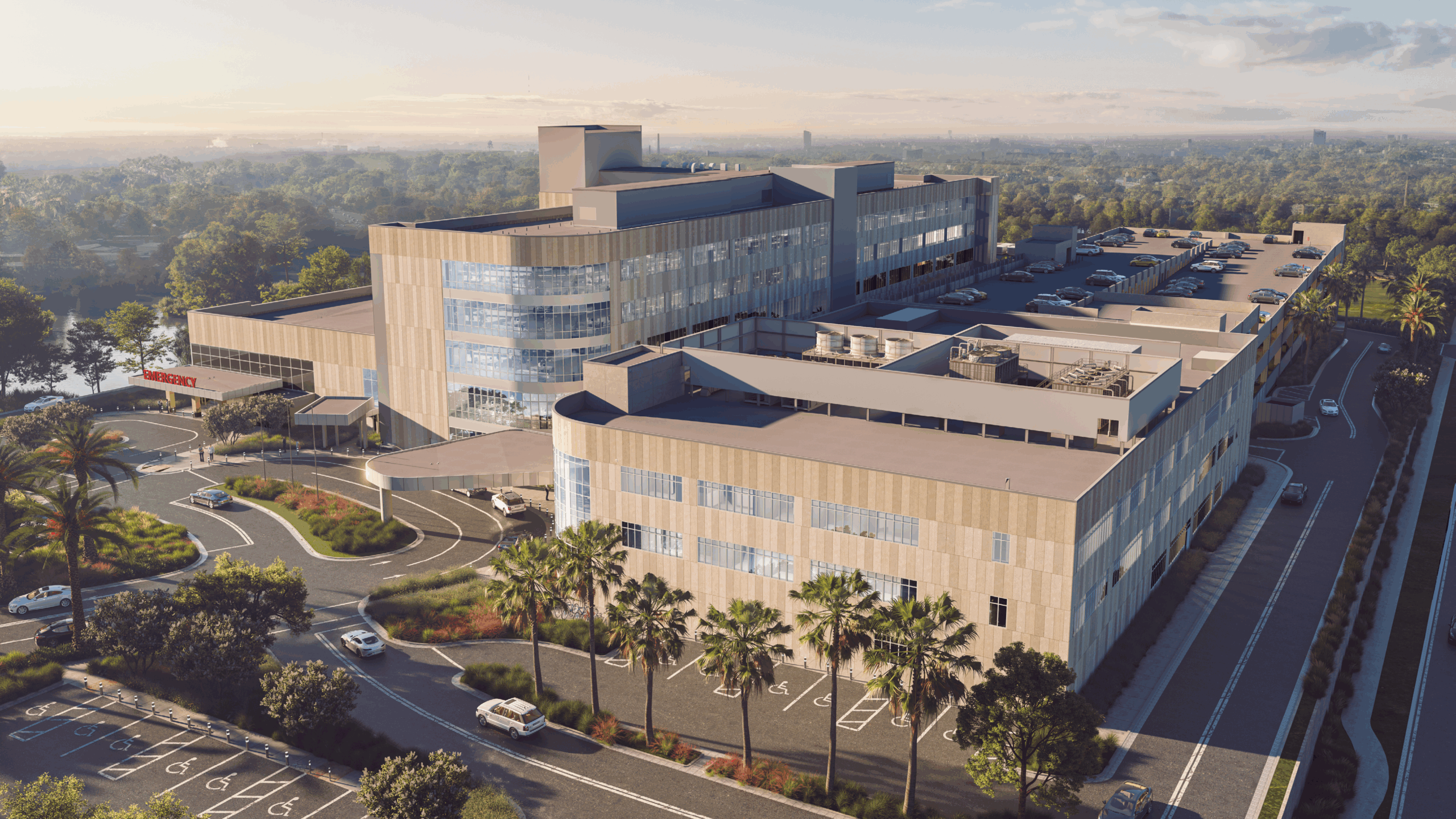 Birds eye view of a building with roads leading to a hospital external entrance.