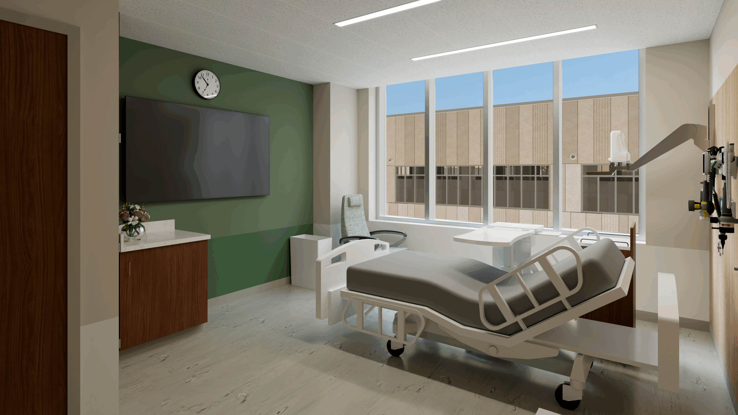 A room with a hospital bed facing a tv on the wall on a green wall and large windows on the adjacent wall.