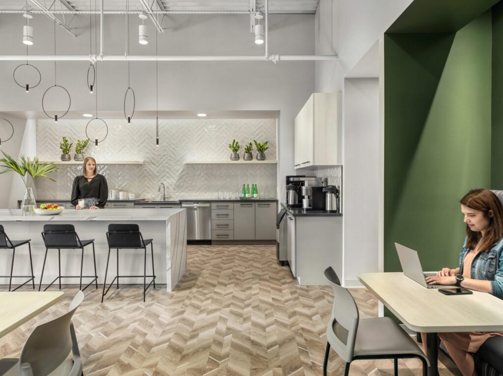 Green office space with two women working