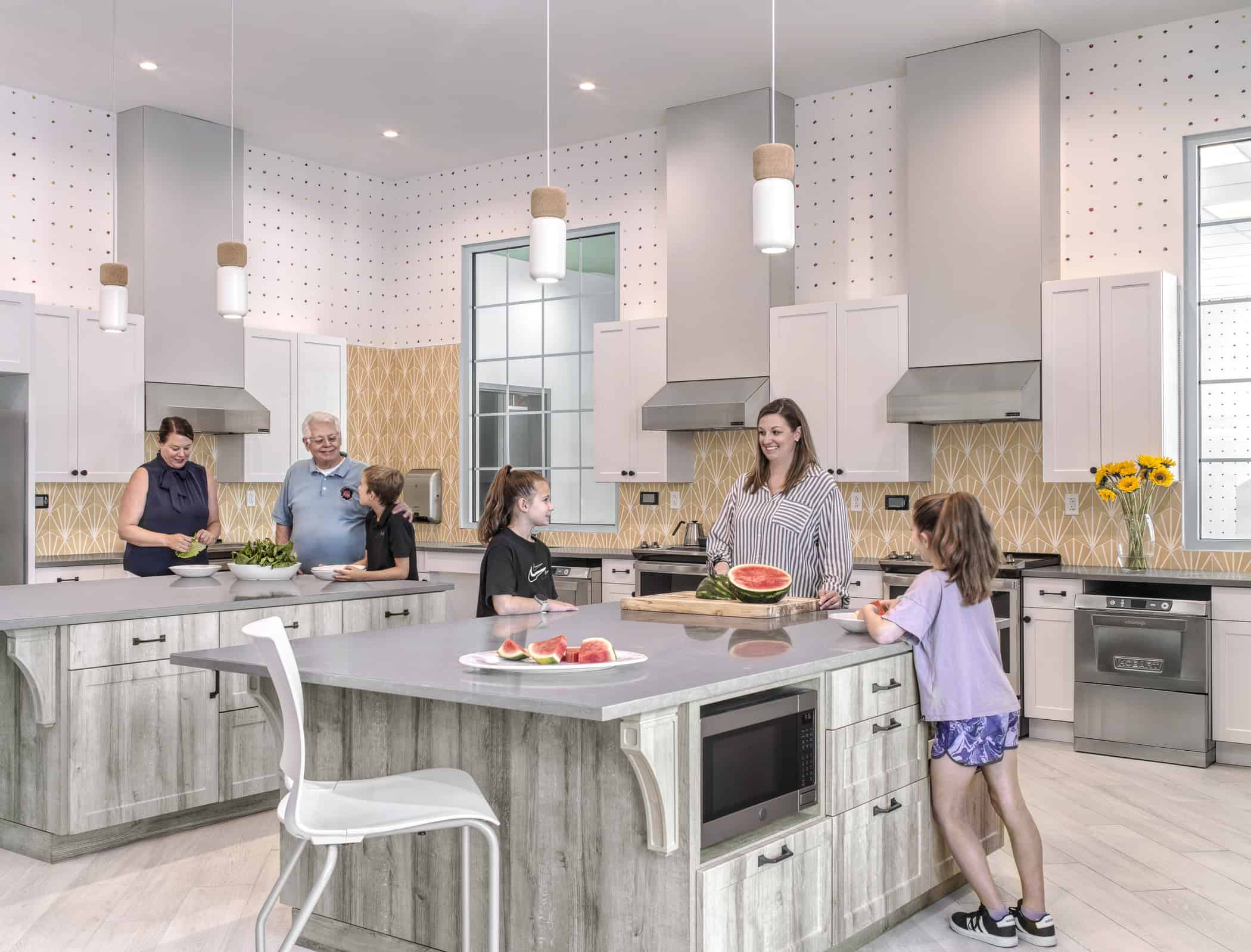 Multiple families prepping kitchen at Ronald McDonald communal kitchen.