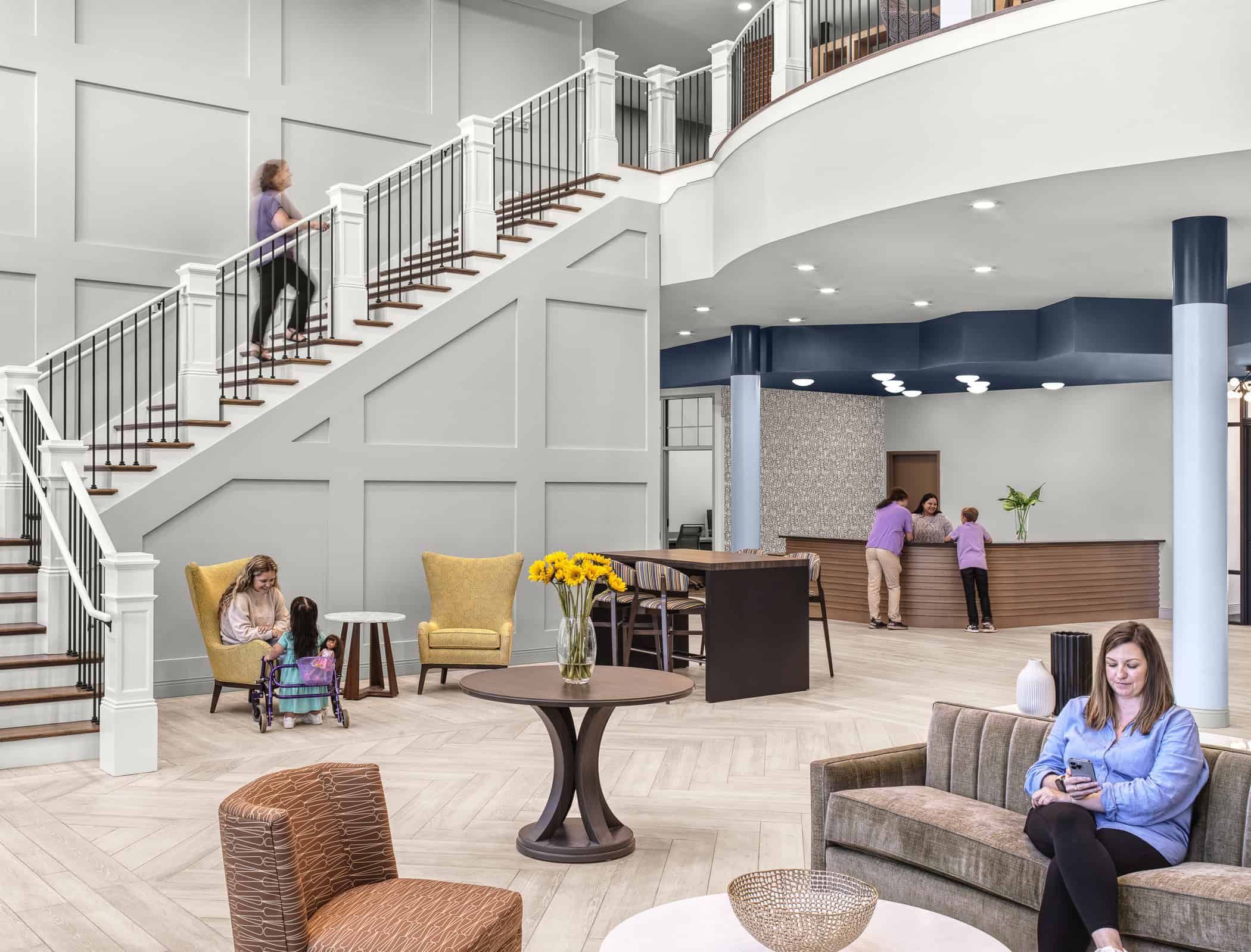 People lounging and walking at the lobby area of Ronald McDonald House