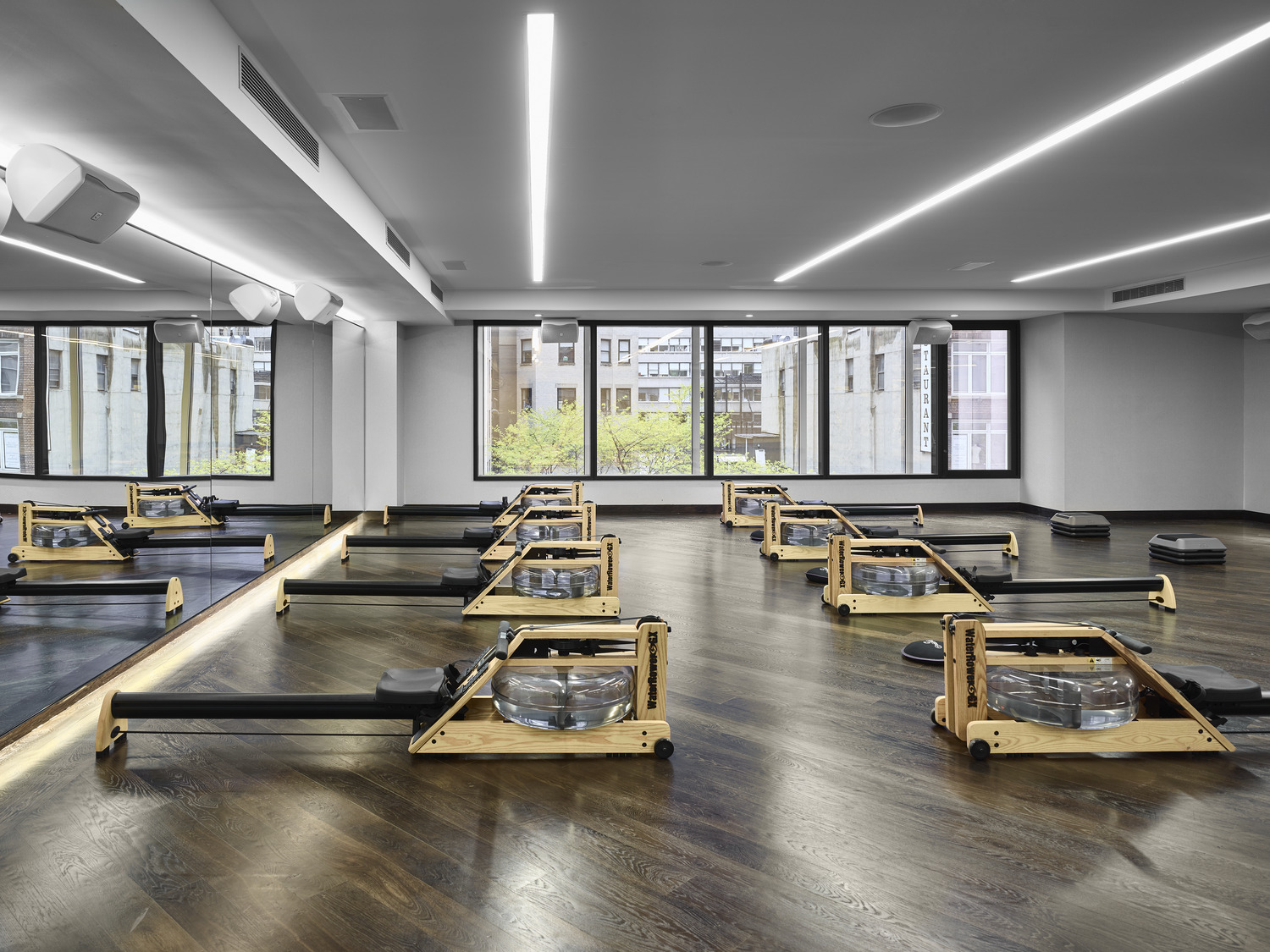 Pilates room filled with rows of reformer machine at Equinox