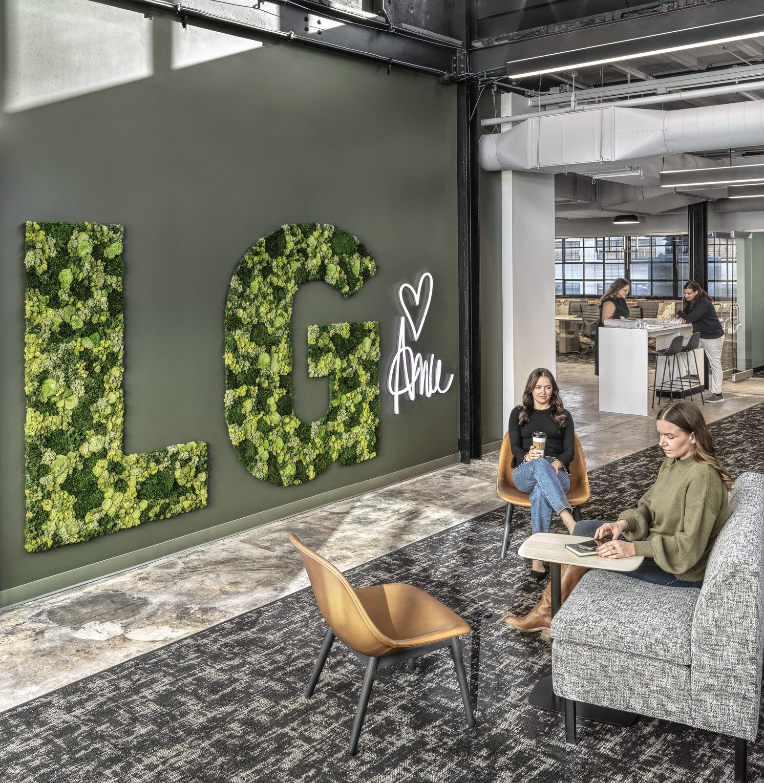 'LG' -shaped moss wall act as an accent wall at the Lochmueller Group office.