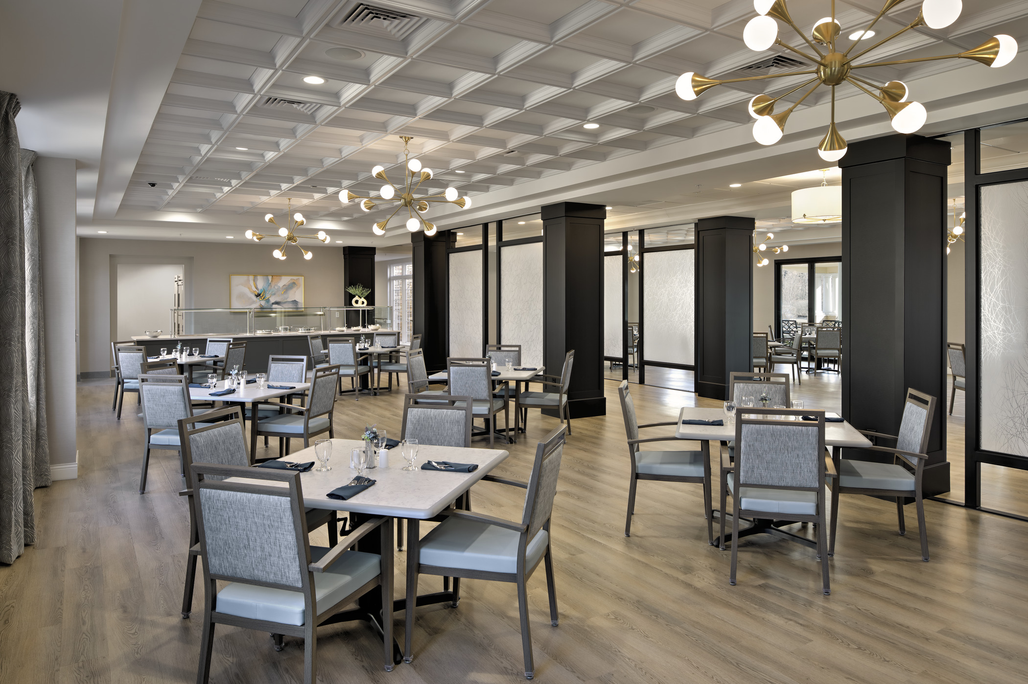 A large multipurpose dining room showcases flexible seating and partitions for the central hallway