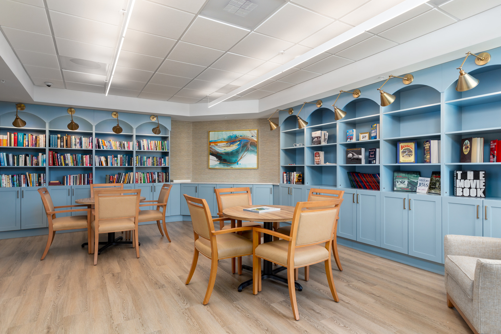 A private library, featuring custom casework and a pastel color palette