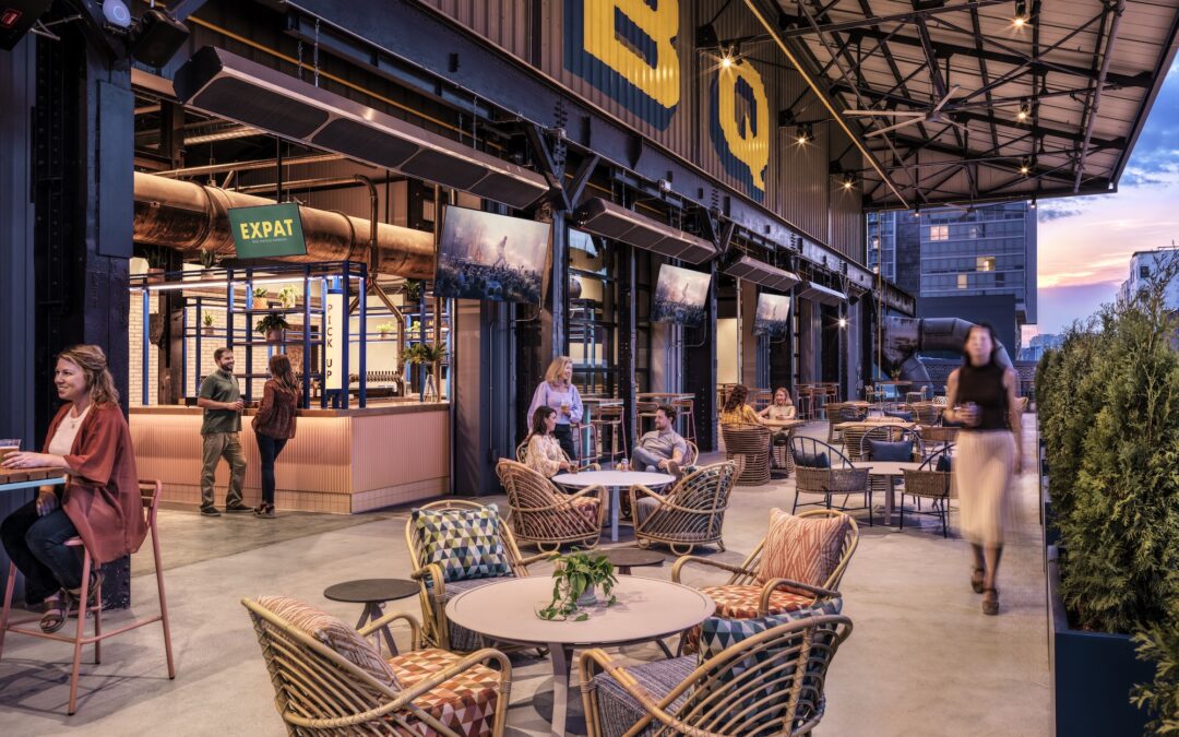 An image of an outdoor patio at a BBQ restaurant with a table and 4 chairs in the foreground