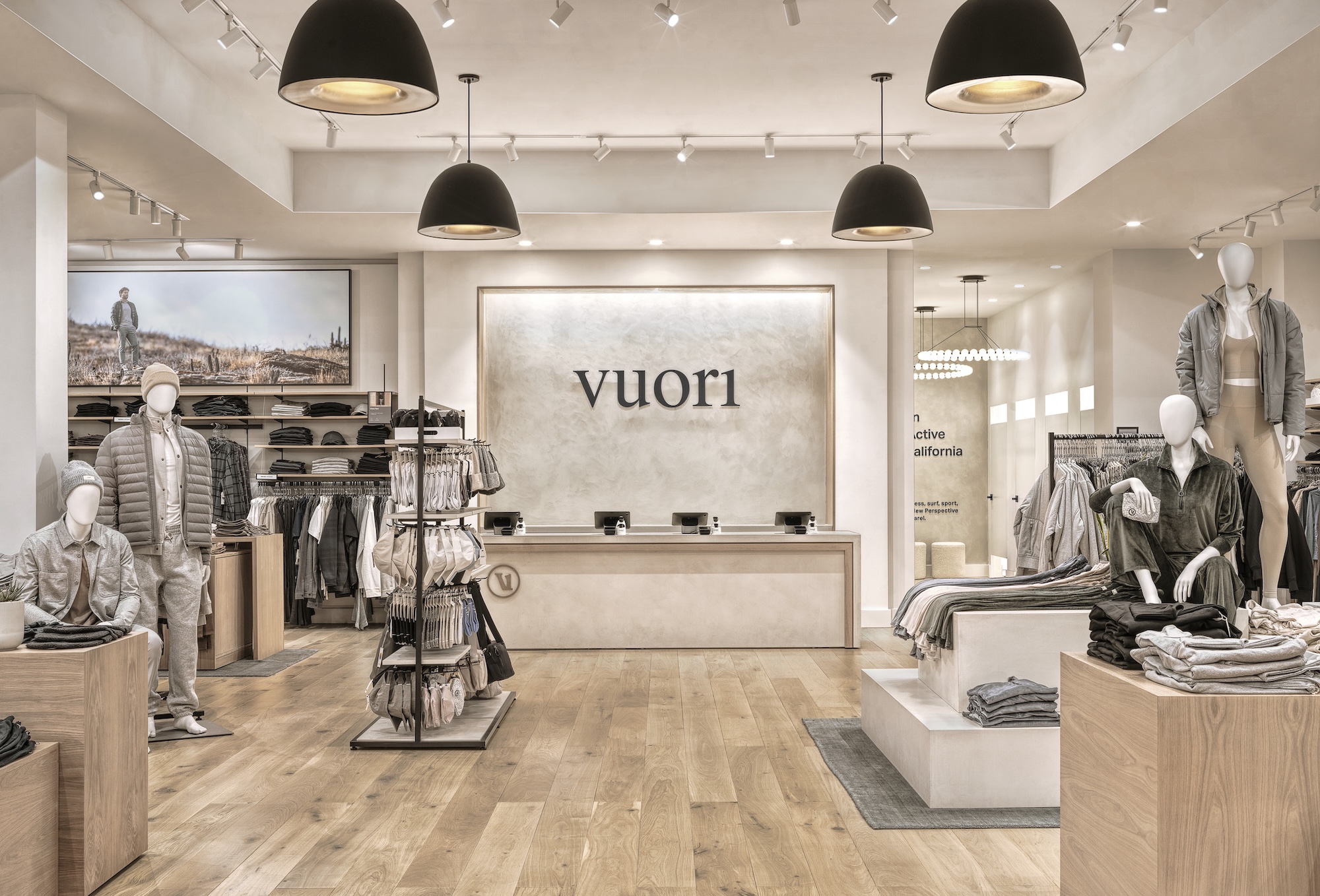 A photograph of the interior of a store. there is a sign that reads vuori in the background and mens clothing in the foreground