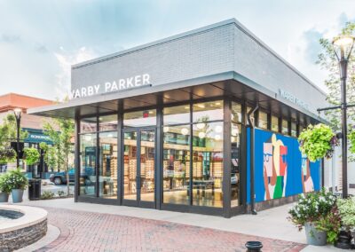 An realistic colorized illustration of a Warby Parker store shown from the outside