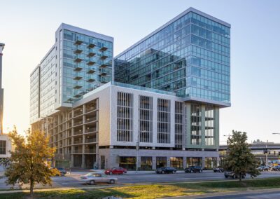 A photograph of the exterior of a modern building made up of rectangles of different materials including glass, concrete, and metal