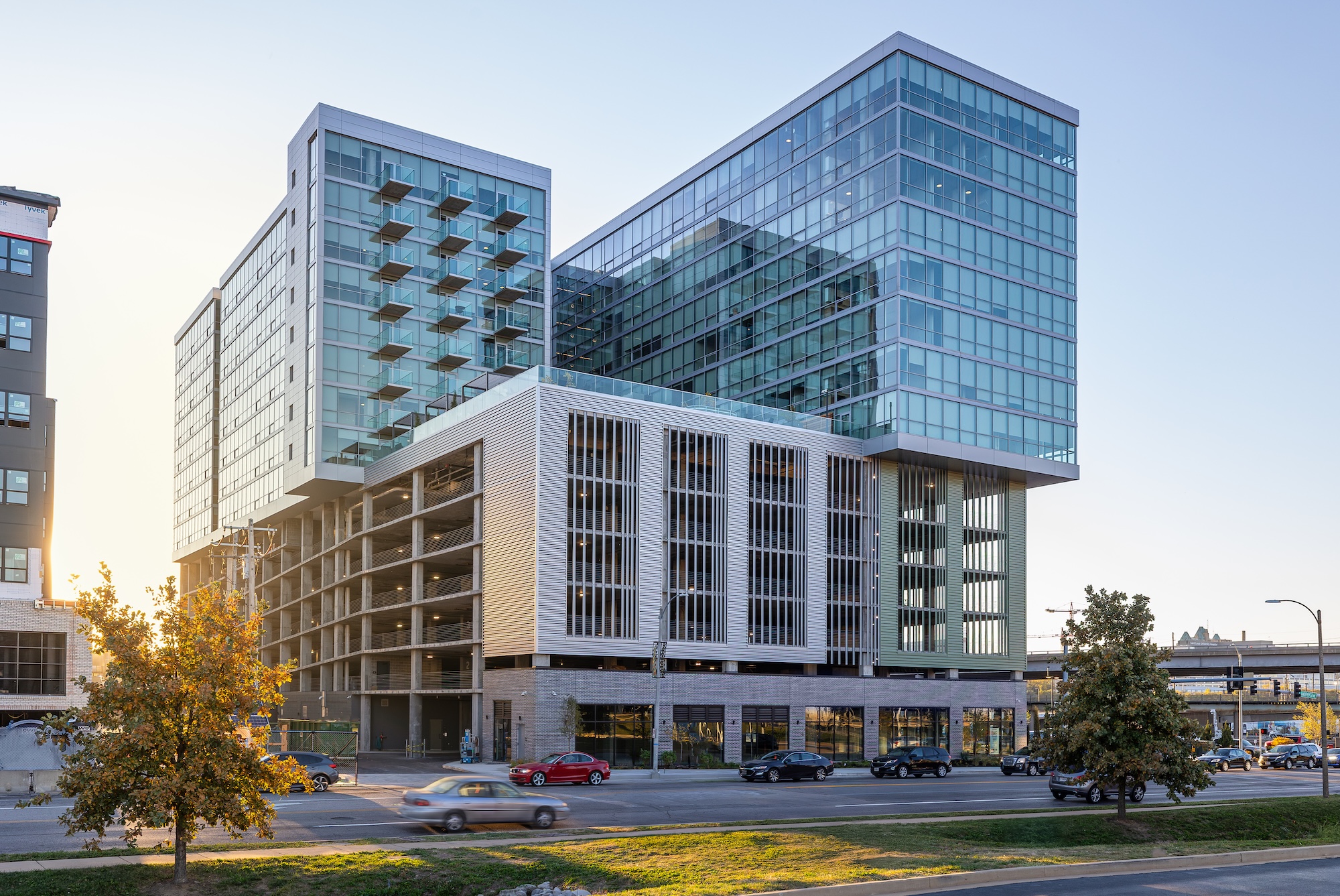 A photograph of the exterior of a modern building made up of rectangles of different materials including glass, concrete, and metal