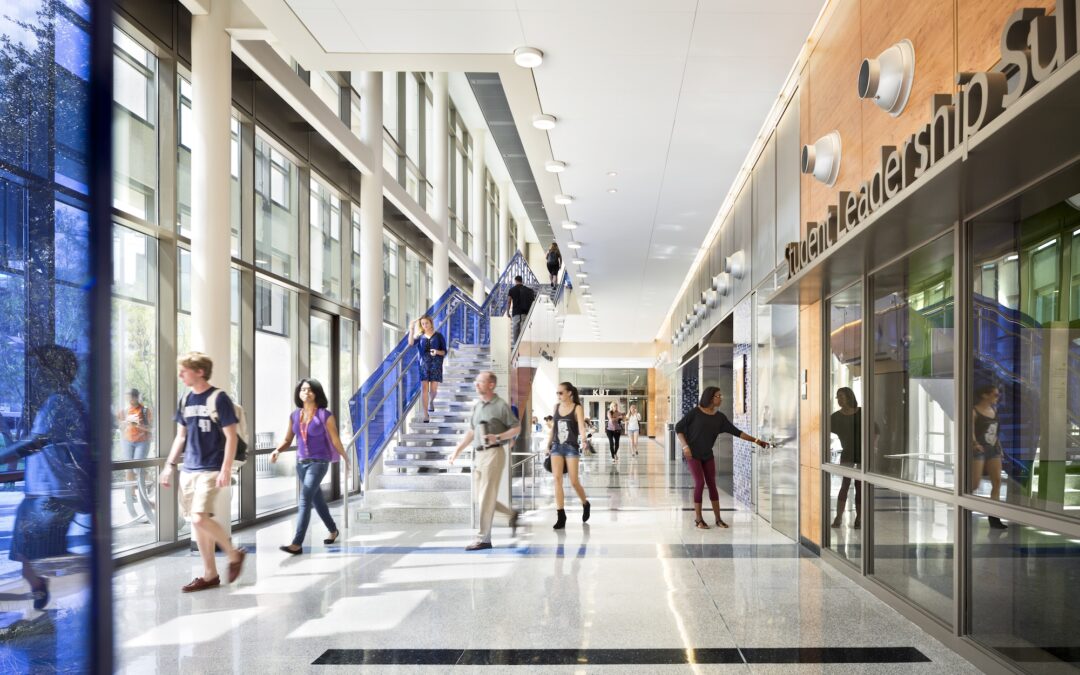A photograph of a public building interior with a staircase leading up in the back