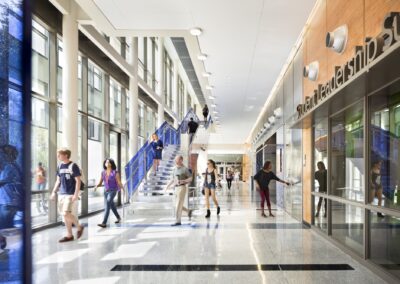 A photograph of a public building interior with a staircase leading up in the back