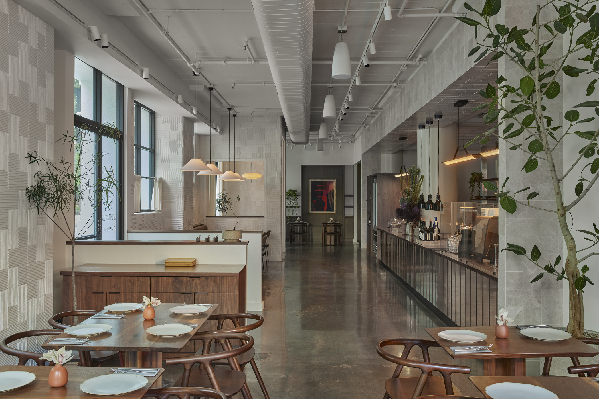 An interior photograph of a restaurant shows the overall seating layout and coffee/drink bar on the right side of the frame