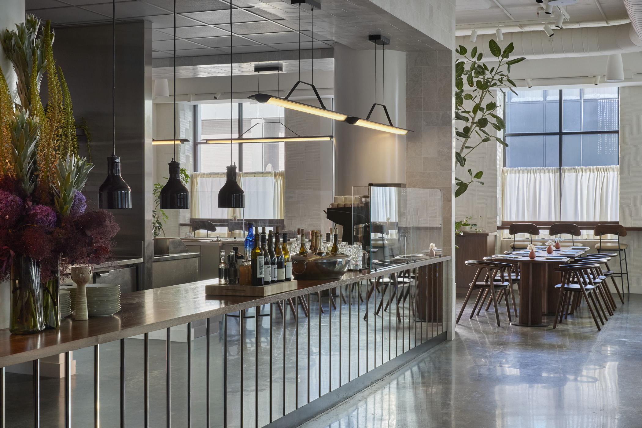 A vignette of an upscale, modern bar in an airy interior restaurant space