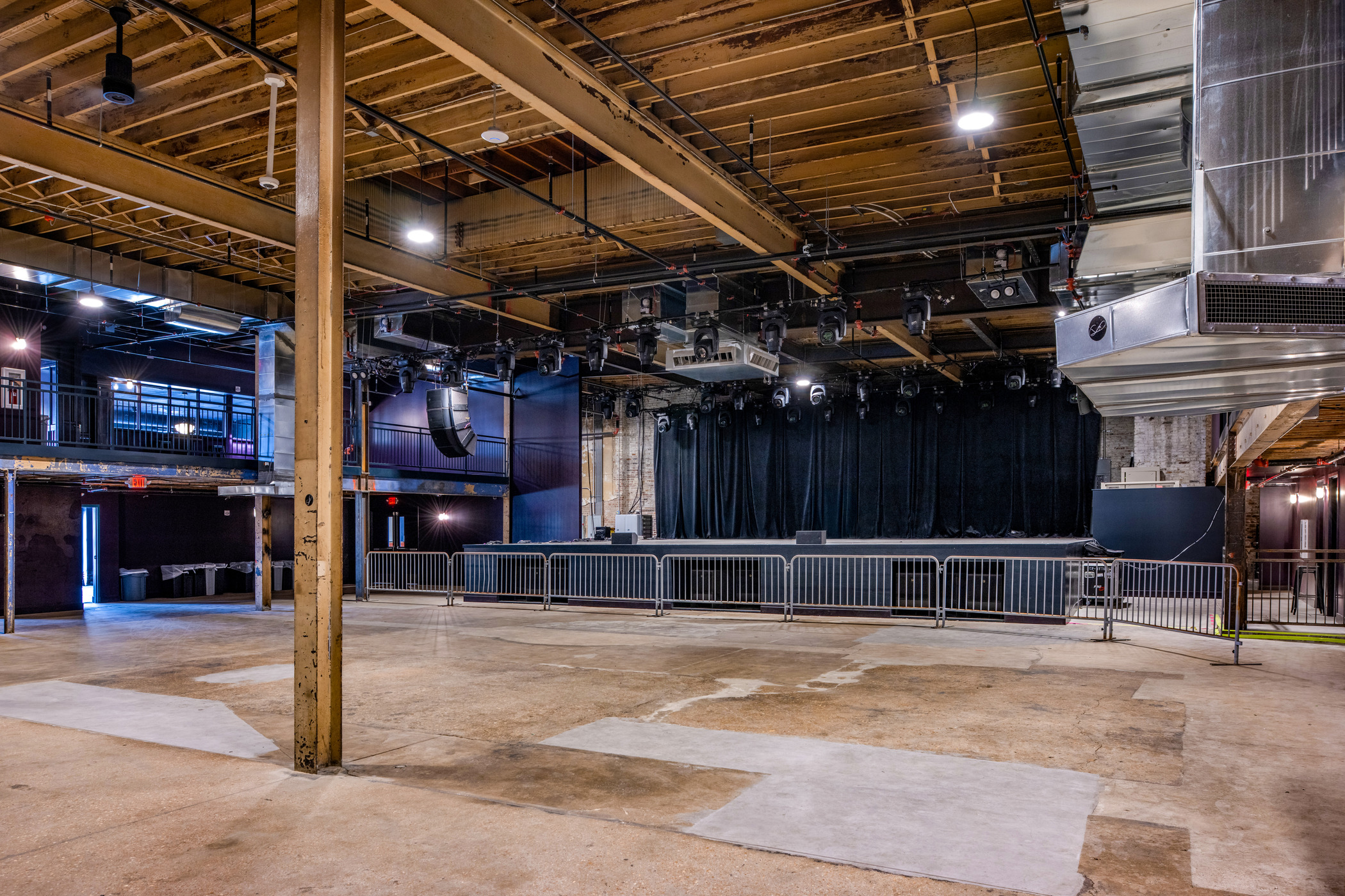 Interior of The Sovereign concert venue in St. Louis featuring exposed beams, stage setup, and industrial architecture.