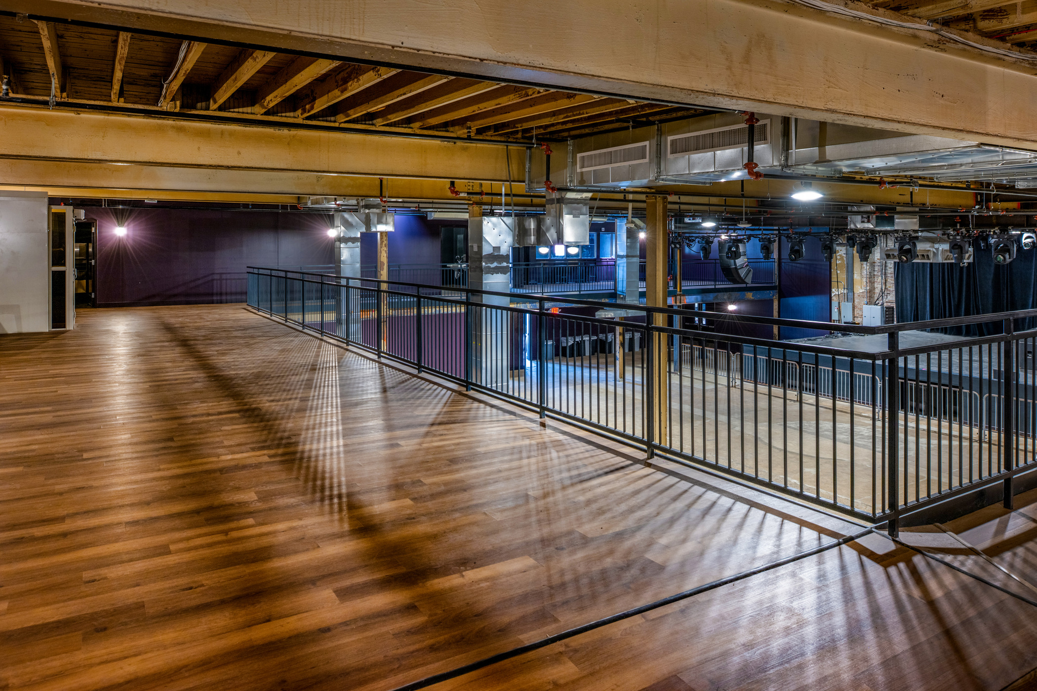 Mezzanine level at The Sovereign concert venue in St. Louis with wood flooring, metal railing, and view of stage.