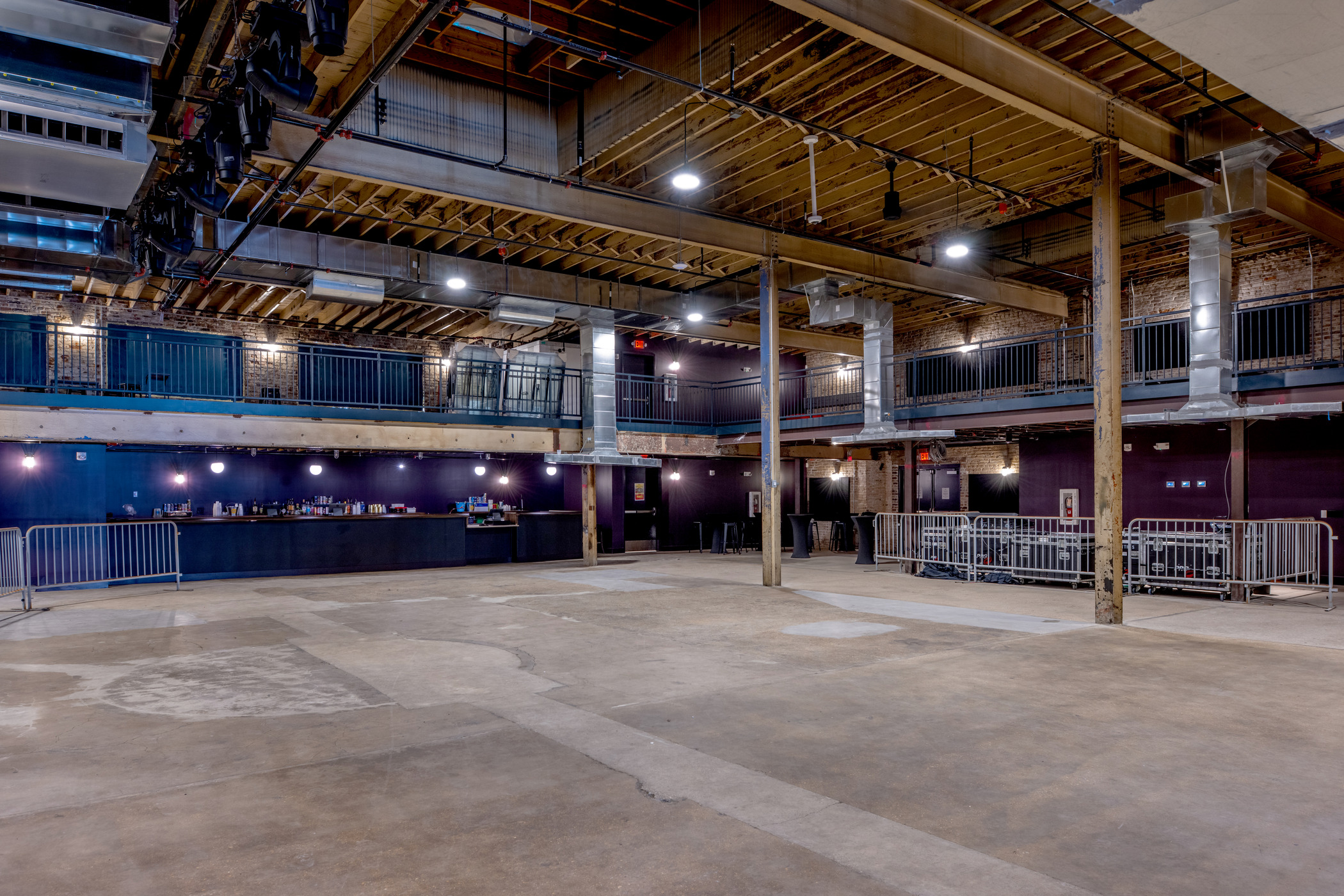 Main floor of The Sovereign concert venue in St. Louis with exposed beams, mezzanine balconies, and industrial design.